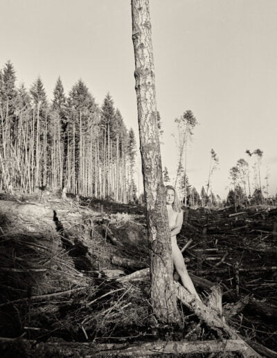 Nude woman in deforested area, deforestation